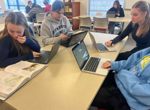 From left, Jordan Kovach, Iris Messore, and Grace Hart calculate the cost of the AP and ECE classes they took. Today, NHS students have the choice of dozens of classes that can earn them AP and ECE college credits while they’re still in high school. (Chief Advocate archives)