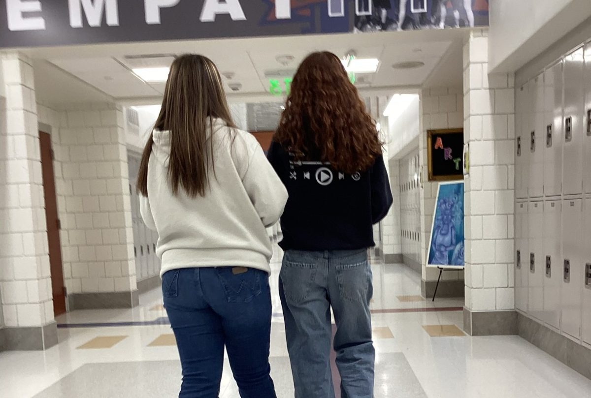Cassidy O'Hayre, left, and Sophia Kallianiotis walk down the hall while they're supposed to be in class.