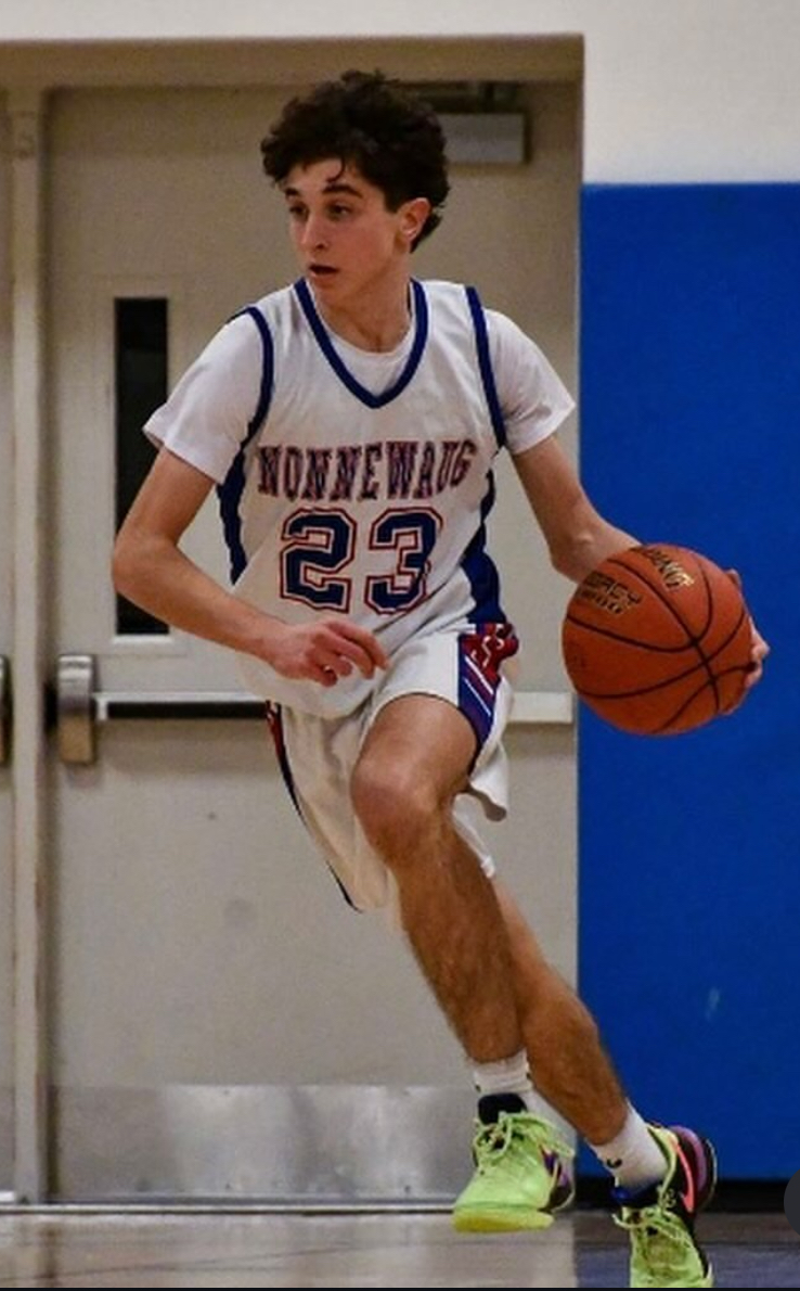 Sophomore Maxton Nichols dribbles basketball up the floor. Nichols is one who at first struggled with stress at the varsity level.