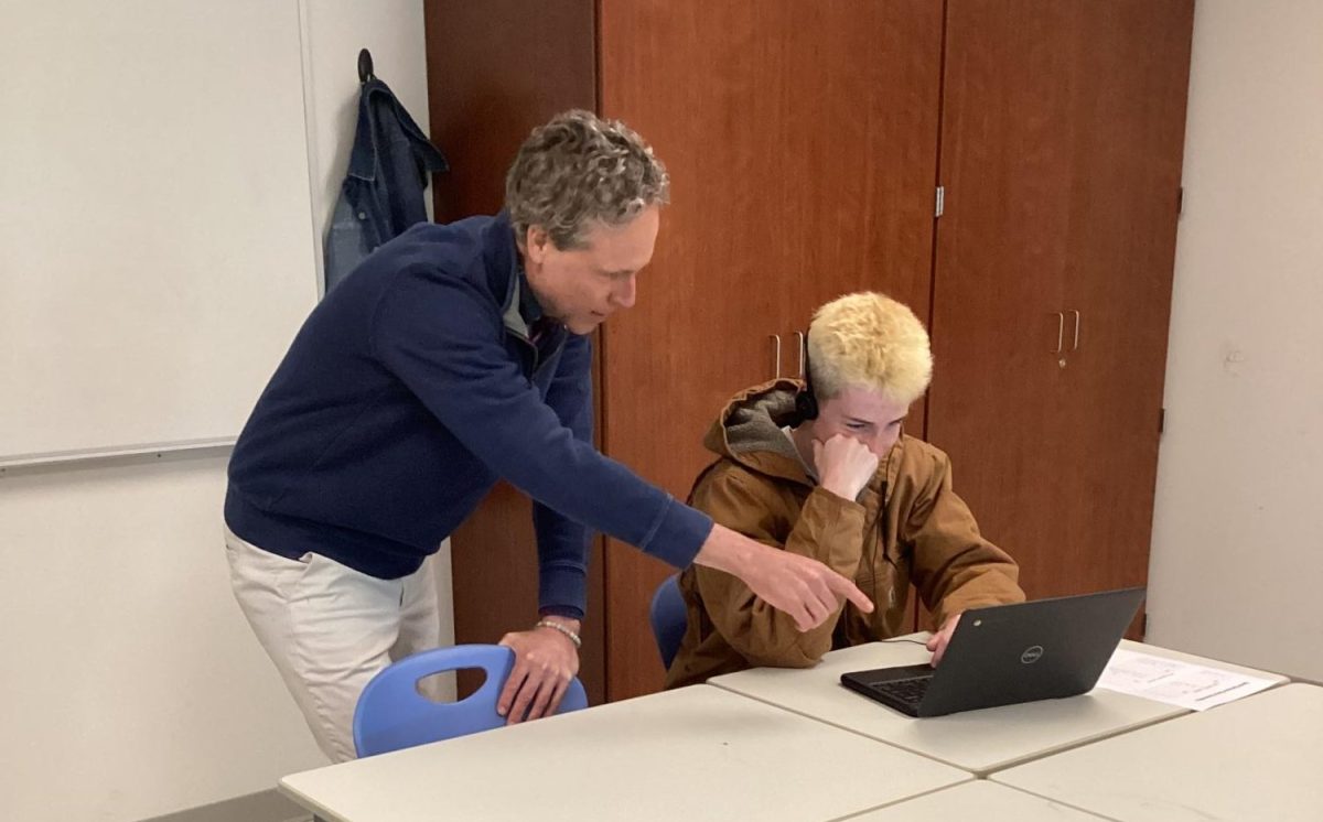 Spanish instructor and Foreign Language Department Chair Matthew Greaves helps a student prepare for the Seal of Biliteracy. Testing began in April and will continue through May.