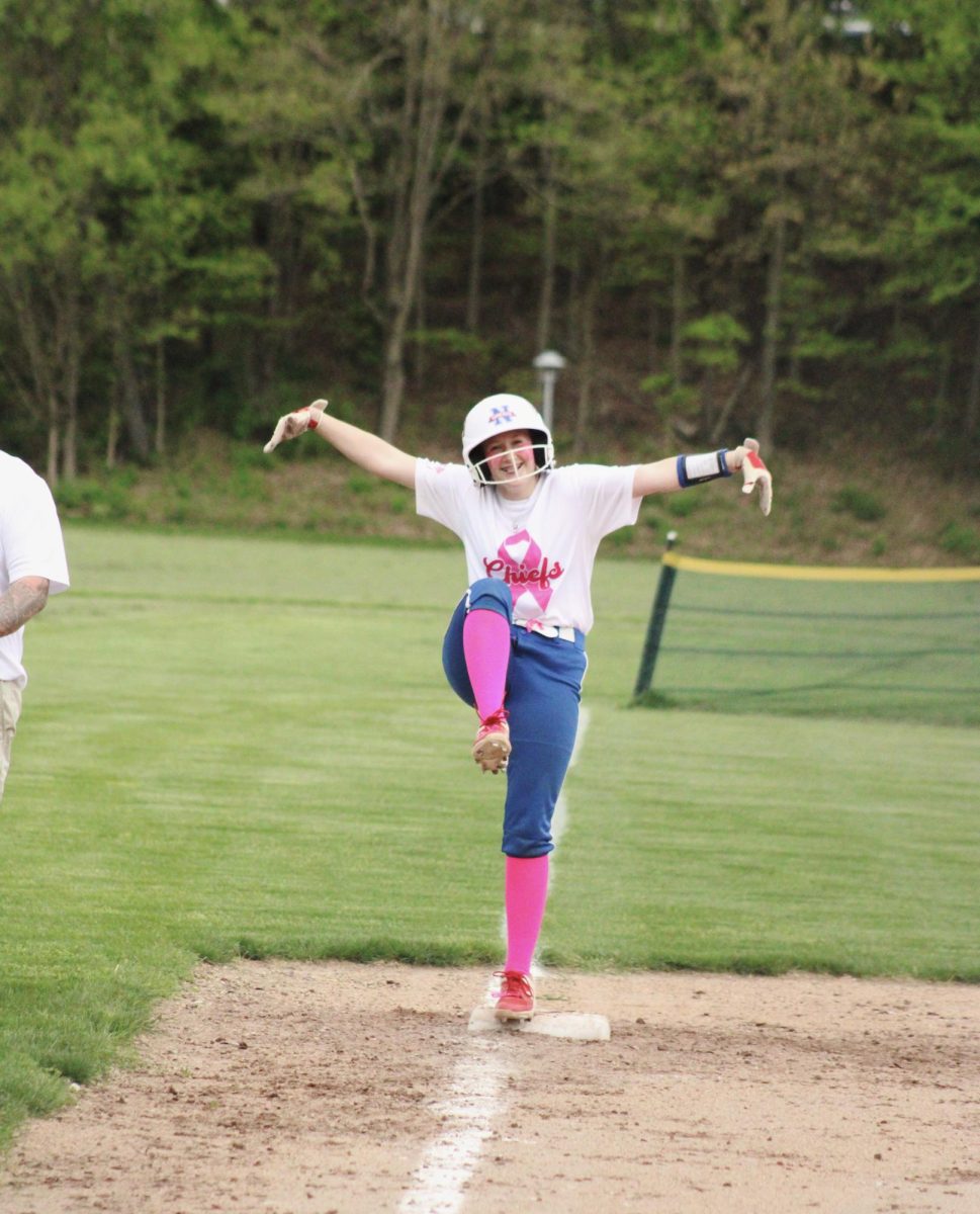 Nonnewaug freshman Lila Farrelly celebrates her triple during the NHS softball game on May 9. 