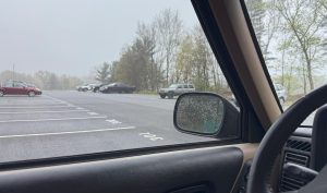 Elsie Crocco's view from the Nonnewaug parking lot in the morning includes a steadily busier traffic scene with loud music and honking.