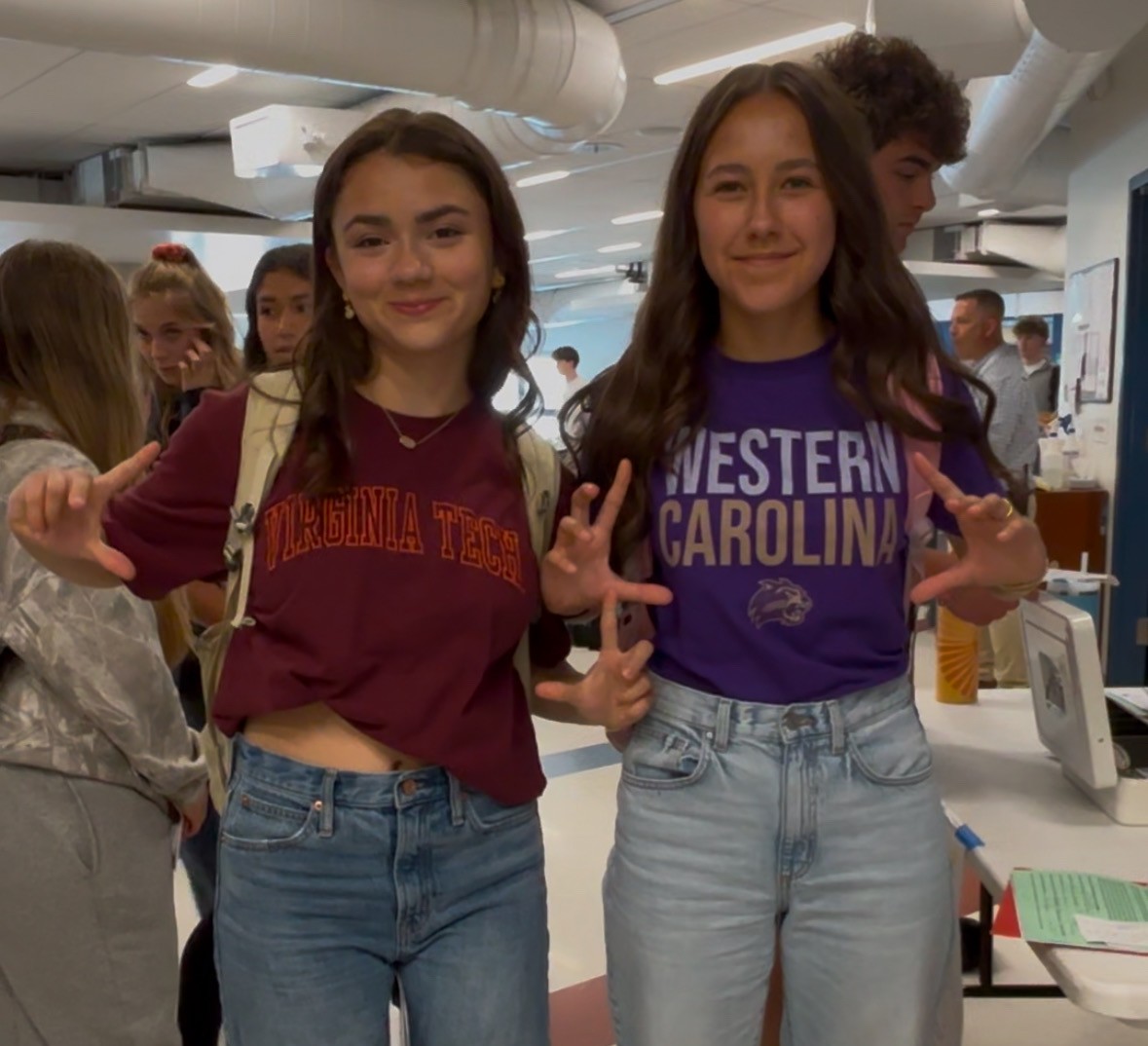 Nonnewaug seniors Eva Ripperger, left, and Karisa Ciszauskas show off their college T-shirts for National College Decision Day on May 1.