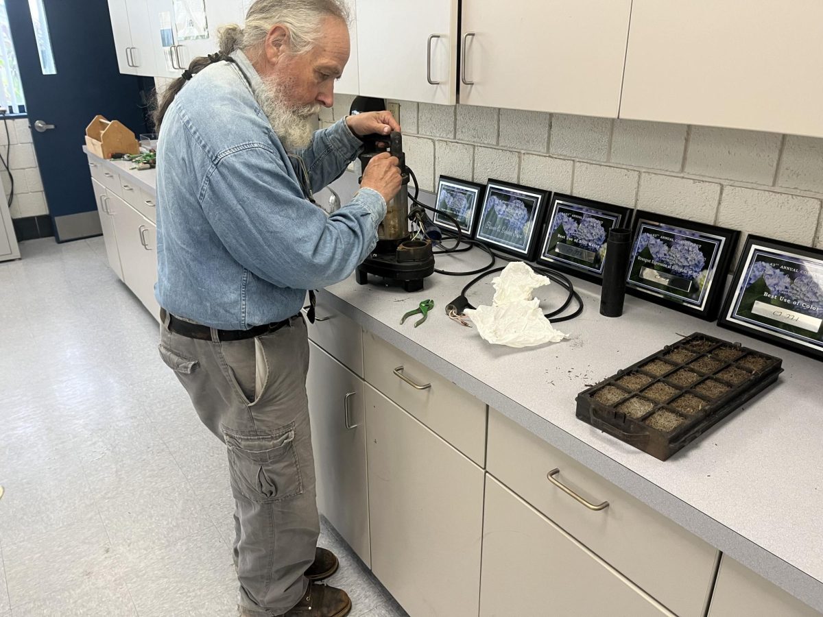 Russ Wabuda, known as “Mr. Fix it,” helps the aquaculture class by fixing the koi pond pump to keep the pond running efficiently. To master a skill like this only comes with time and experience which Wabuda has a lot of. 