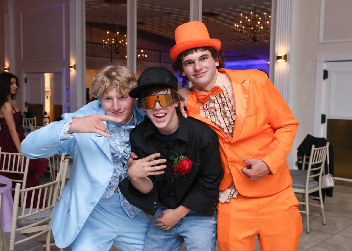 From left, R.J. Barksdale, Aiden Moffett, and Jakob Reynolds pose at the prom on May 25 at the Aqua Turf Club. (Courtesy of Images Studio)