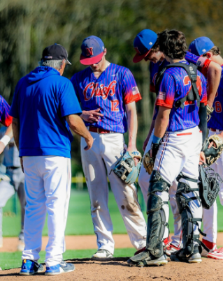 Nonnewaug baseball teammates stand on the pitching mound and discuss a game plan with head coach Jimmy Alberto during one of their games. (Courtesy of Noreen Chung)