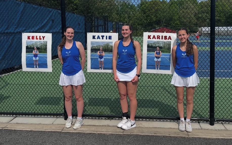 Seniors on the girls tennis team, from left, Kelly Farell, Katie Farrell, and Karisa Cizauskas, pose for a picture at their senior day match against Northwestern.