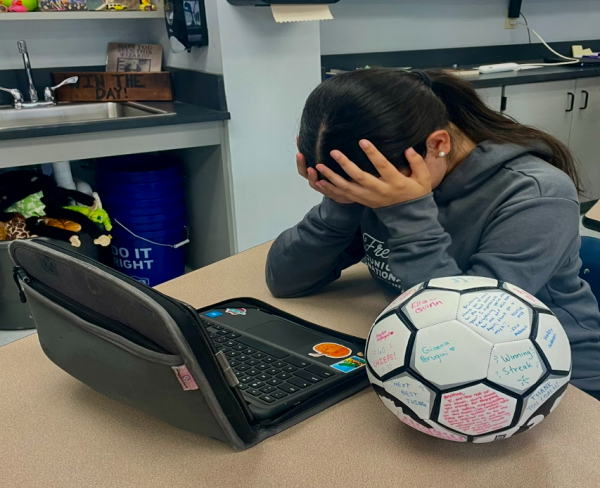 Cora Grogean, an eighth-grade student, looks distressed while 
worrying about schoolwork and athletics. (Stella Stein '29)