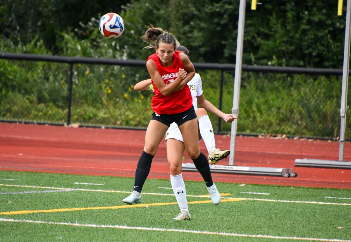 Hailey Goldman heads the ball on August 28th during the girls soccer team scrimmage against Holy Cross.
