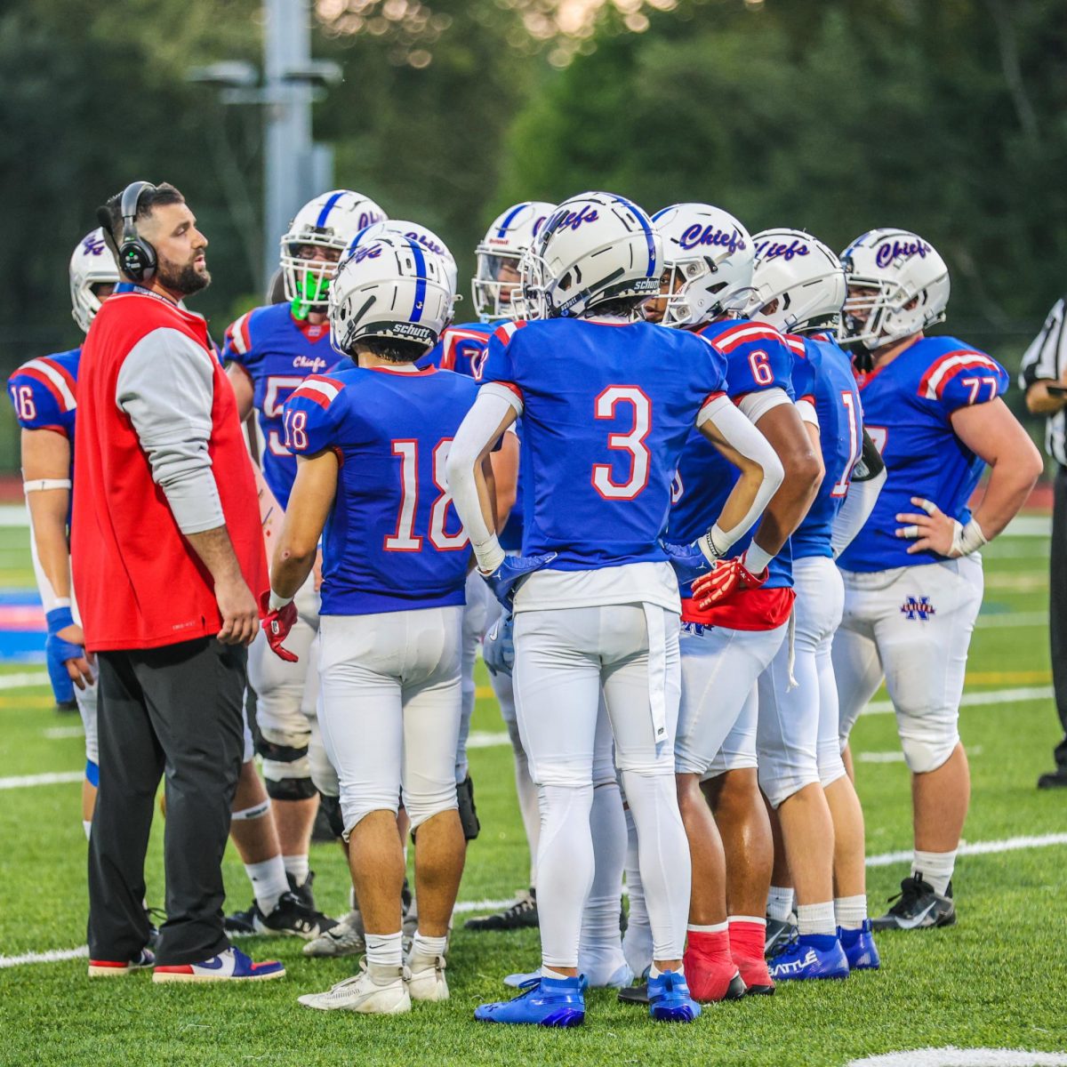 Scott Lynch, Nonnewaug's newest addition to the coaching staff, stands with his team before a game. NHS football is one of many teams adapting to new coaching this season. (Courtesy of Noreen Chung)
