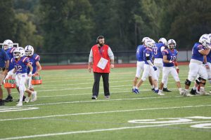 Nonnewaug football coach Scott Lynch stands on the field after a timeout during their first game on September 12, 2025. (Courtesy of Noreen Chung)