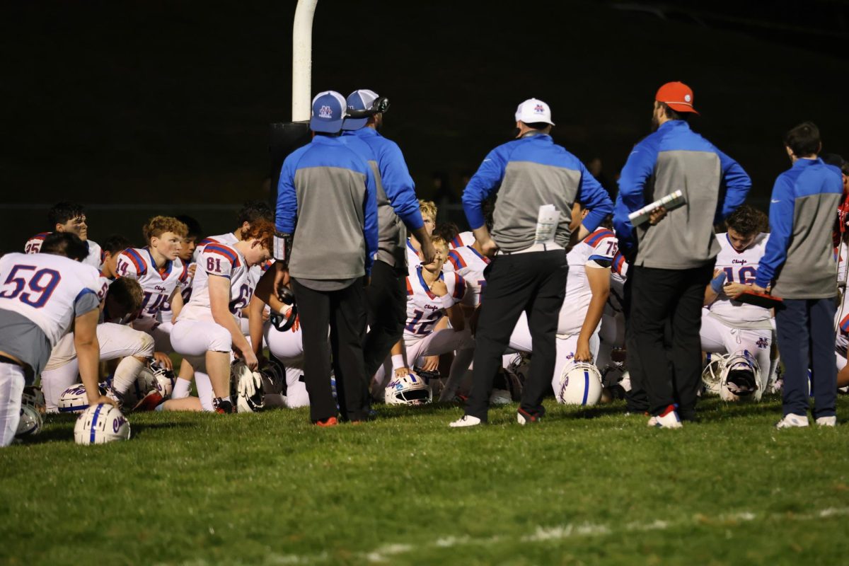 NHS Chiefs football players listen to the post-game talk with new coaches on Sept. 19th against PlainField High School. (Courtesy of Noreen Chung)