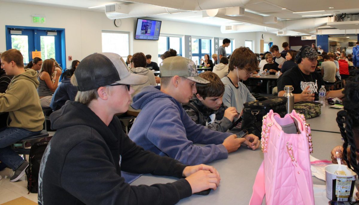 Freshman Anthony Popielasz (left) socializes during lunch with other freshmen