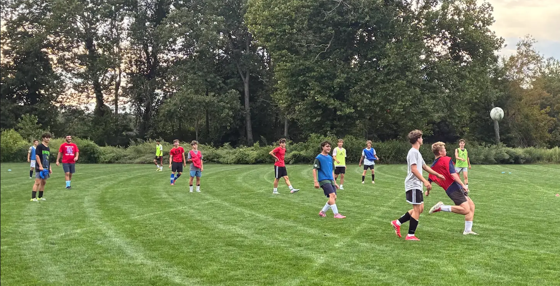 Boys soccer players fight for the ball at a practice on the Nonnewaug field during a summer practice. These summer sessions provided teams added opportunities to learn plays, assimilate new players, and get a jump start on next season. 

