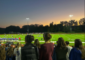 NHS students look on during Nonnewaug football game, under the lights, Friday,September 12th. It's common at NHS to see athletes cheer at all sporting events. 