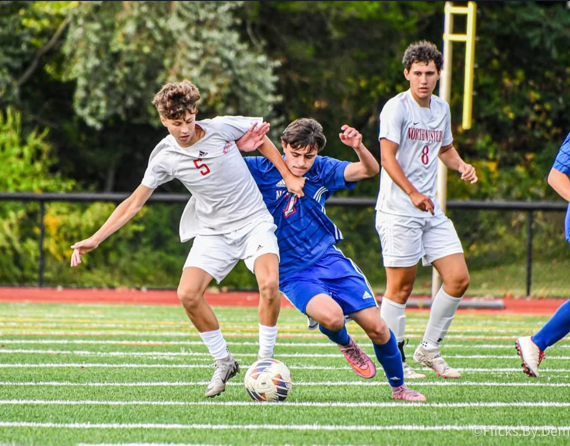 Junior Josh Zapatka (7) fights for the ball in a game against Northwestern on September 9th at Nonnewaug turf. Boys and girls soccer has seen a growth in numbers which fortunately helps this year's NHS boys soccer team which has increasingly relied on underclassmen to step up through a rash of late September injuries. 