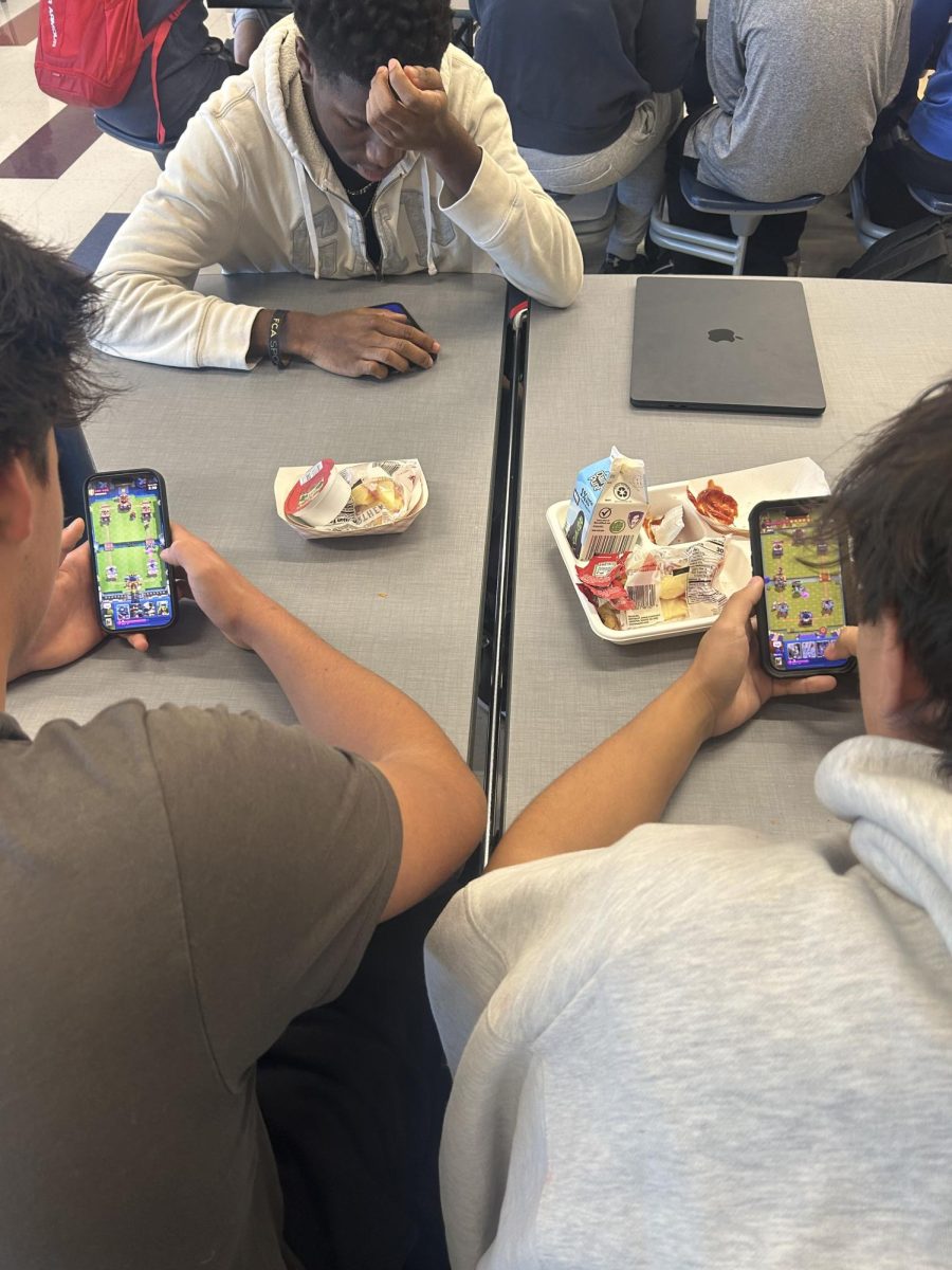 Nonnewaug seniors from left to right Owen Fitzgerald, Micah Maberry, and Jonathan Cheung indulge in a game of clash royale while enjoying their lunch.
