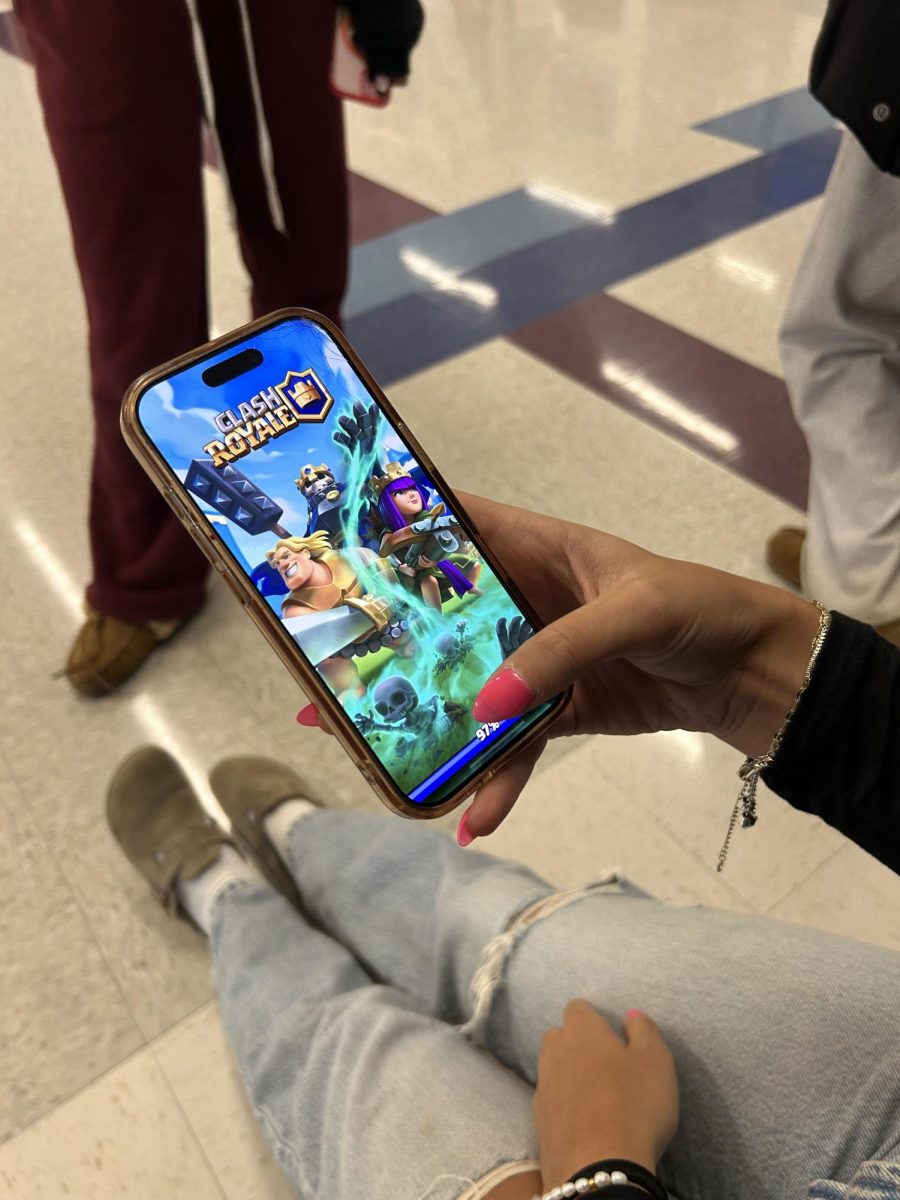 Junior Audrey Doran loads into Clash Royale for the first time just after downloading it. Recently many Nonnewaug students like Doran have made Clash Royale accounts. 
