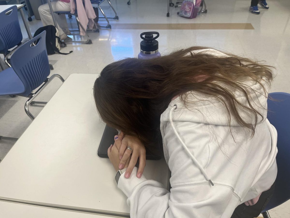 Freshman Madelyn DeGruttola has her head down in class. Increasing numbers of absences on block days due to illness has become a growing issue at Nonnewaug.
