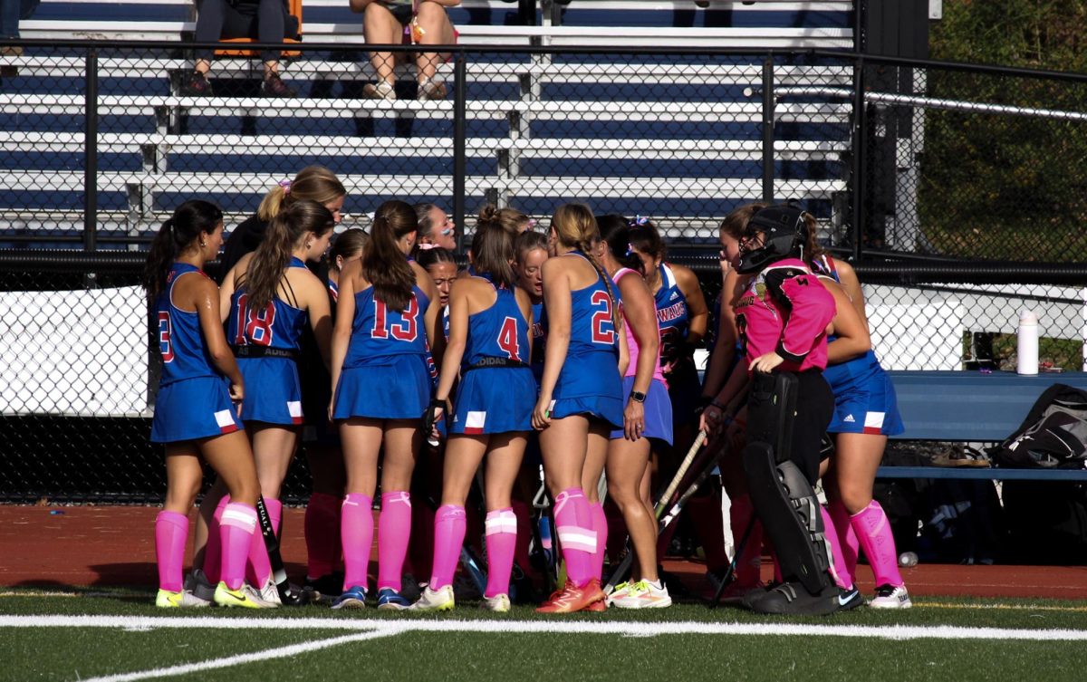 The Nonnewaug field hockey team joins together in a huddle to cheer before going out on the field during the Homecoming Game against Shepaug on October 2nd. 
