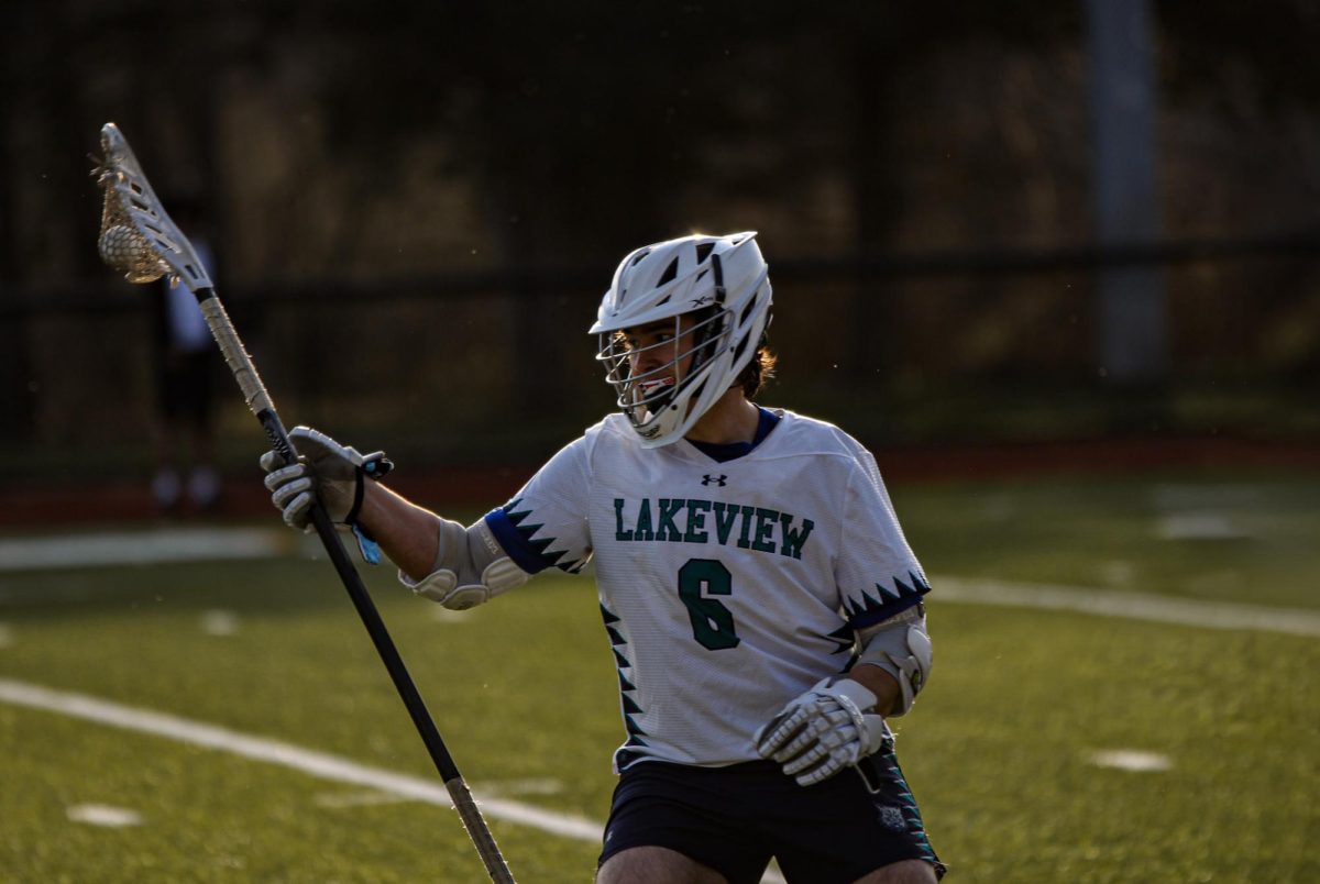 Lakeview senior Edward Allen (6) cradles the ball to avoid the defense during a 2025 regular season game. The Lakeview co-op provides opportunities for athletes in surrounding schools to create new connections and memories. This co-op, however, creates new challenges for student-athletes trying to bridge the distance the connects each town. 