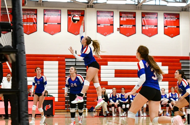 Captian Macey Chmiel spikes the ball against the opposing team. This year the volleyball team has put in extra work to get this far in state championships. 