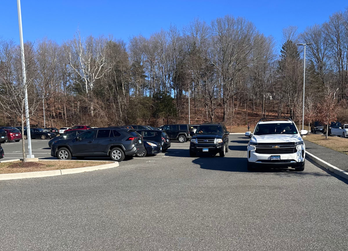 In the student parking lot, parents block students' cars as well as students' view of people walking.