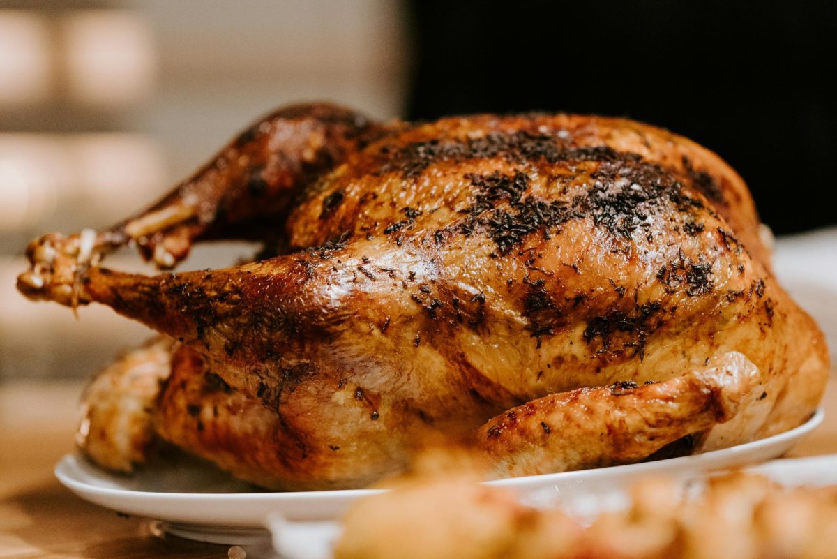 A turkey is traditionally prepared on Thanksgiving for when friends and family gather to eat and enjoy the holiday. For some families, Thanksgiving is a key holiday, while others skip right past it to celebrate the winter holidays early. (Photo Credit: Claudio Schwarz - Unsplash