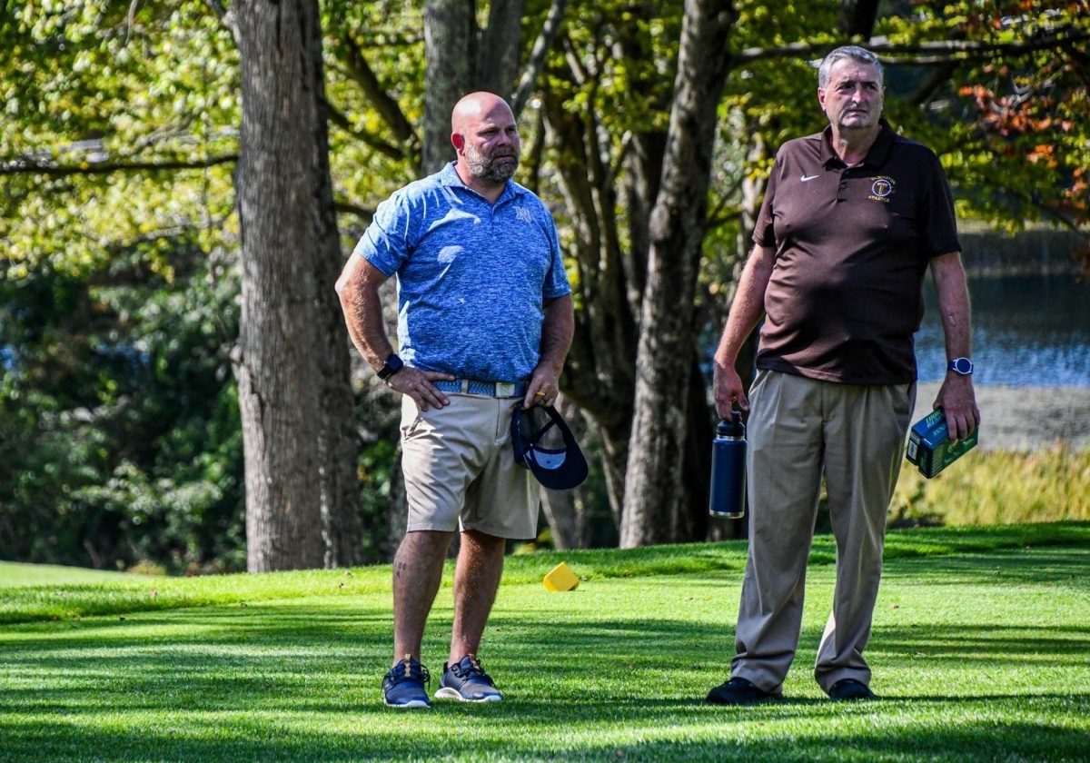 Coach “Camp” watches as his players tee off in their final match of the year against Thomaston during the 2025 season alongside THS coach Michael Watson. This match is what sealed the Berkshire League title for Campanario and his Chiefs.