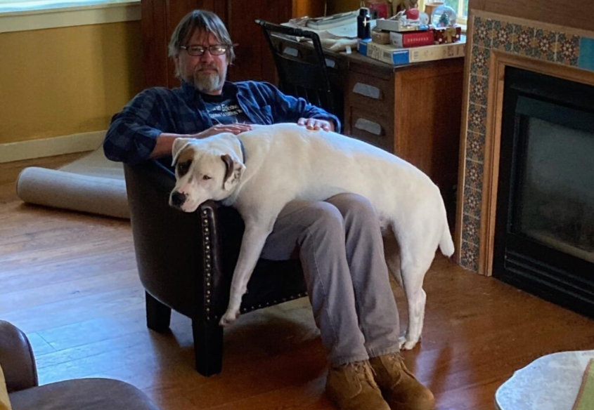 Steve Bunovsky sits with his dog, Rex. Bunovsky is a valuable staff member of the Nonnewaug community, engaging students in their learning and creating a comfortable environment. (Courtesy of Steve Bunovsky)