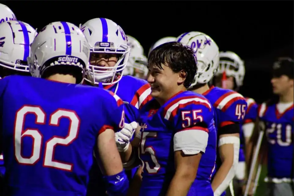Jonathan Cheung (55) surrounded by his teammates during a football game this fall. Cheung’s November diagnosis has helped to galvanize NHS’ entire community and remind those closest to him that we’re all Cheung Champions. (Photo Credit - NHS Athletics)