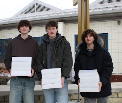 NHS culinary students Seamus Ryan, Finn Farrelly, and Trevor Timko prepare to deliver meals during Thursday's Senior Citizen drive-thru. 