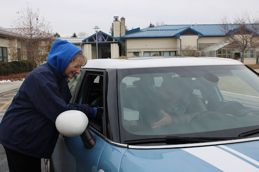 NHS senior McKenna Hardisty distributes a meal to a community member at Thursday's Senior Citizen Meal. The NHS culinary department puts on an annual fall and spring drive-thru luncheon for the Bethlehem-Woodbury community. 