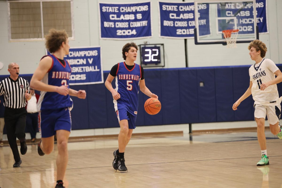 Senior Brady Herman hustles down the court to get a shot off before the shot clock buzzer on rivals night January 9th. The shot clock has been a key factor for the players these past three years. (Courtesy of Noreen Chung)
