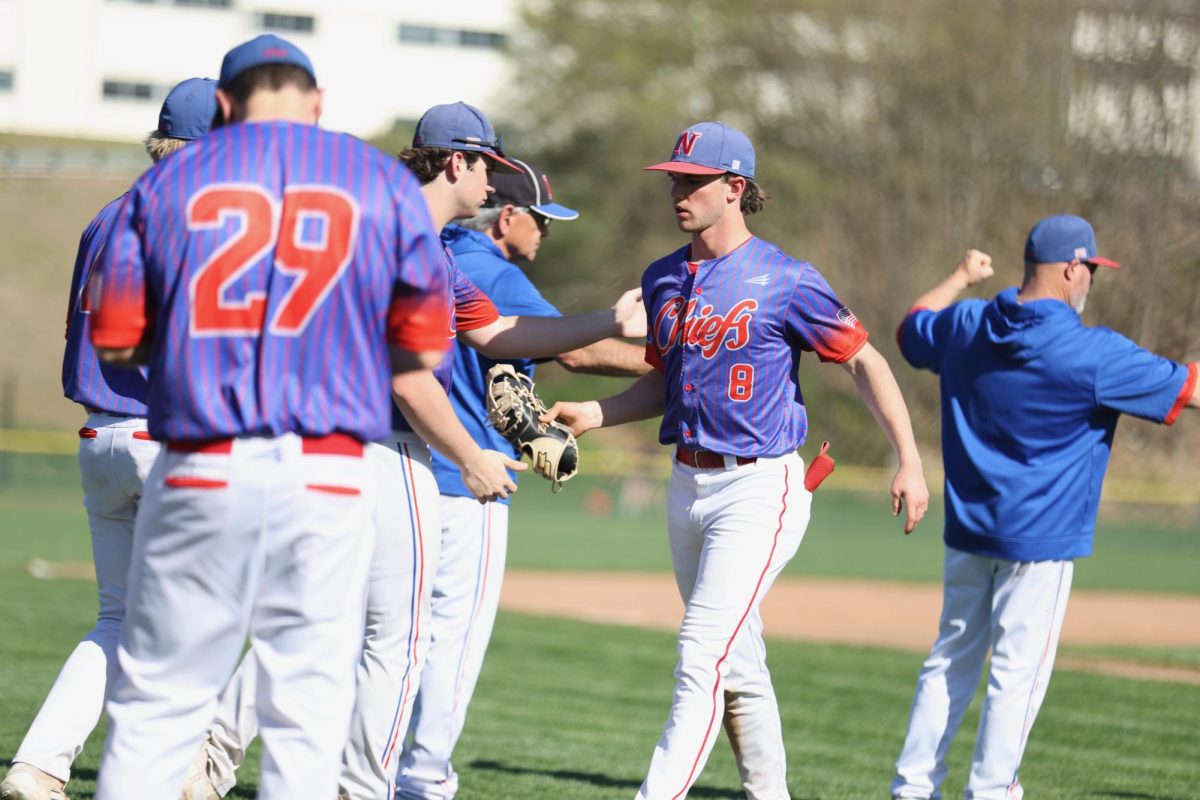 Brayden Whipple (8) greets his teammates during last season's Senior Day. Whippple is one of the few seniors on this year's team who played a contributing role as a freshman, though Whipple's athletic success is only part of what makes him such a critical member of NHS' '26 class. (Photo Credit - Noreen Chung)