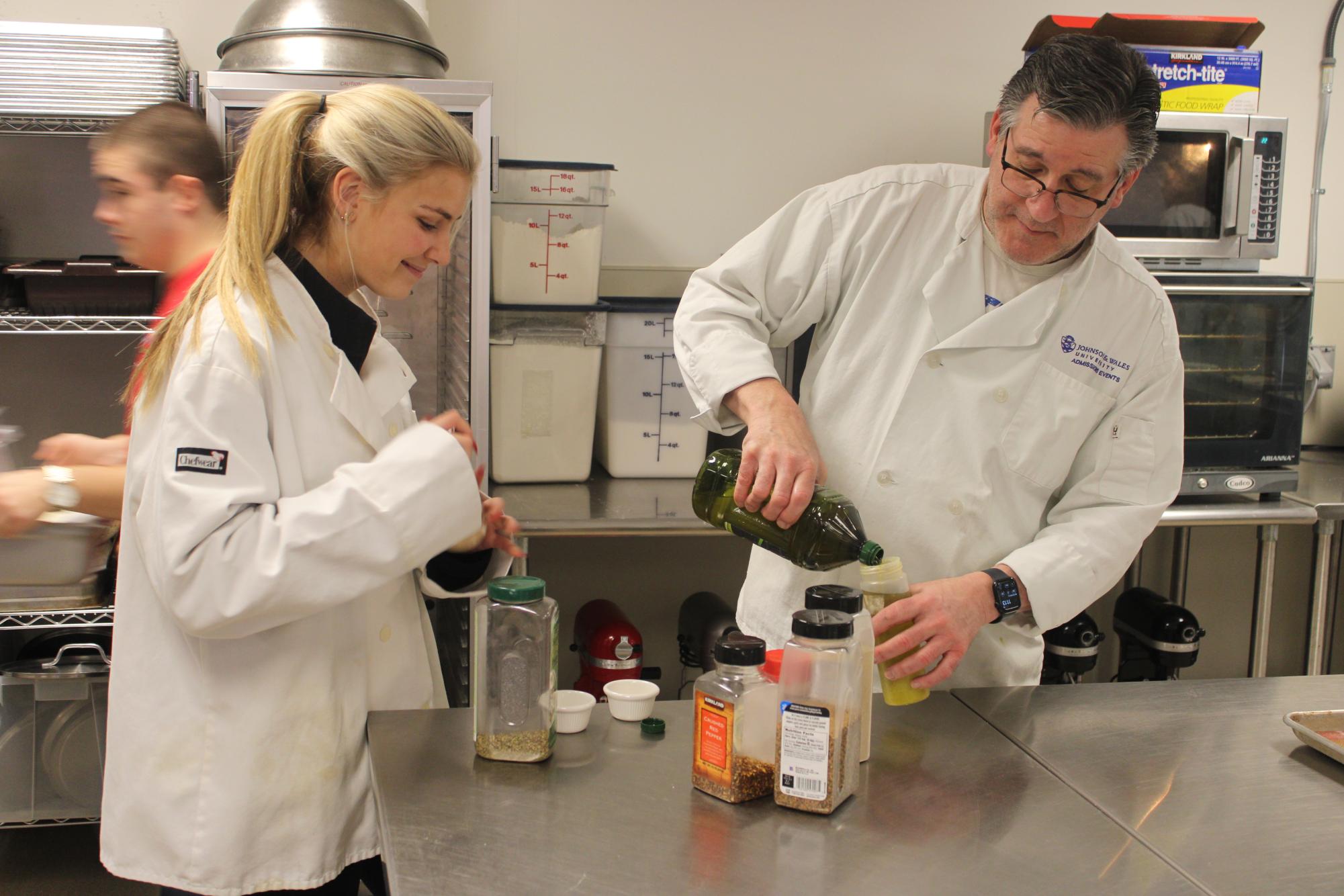 Dominello and advanced culinary student Aubrey Salisbury work with some of the many spices that his students have available to them in his kitchen. Students, under the direction of Dominello, create new dishes weekly, each one from a different culture or background, giving his students the experience of working with many different types of food. 