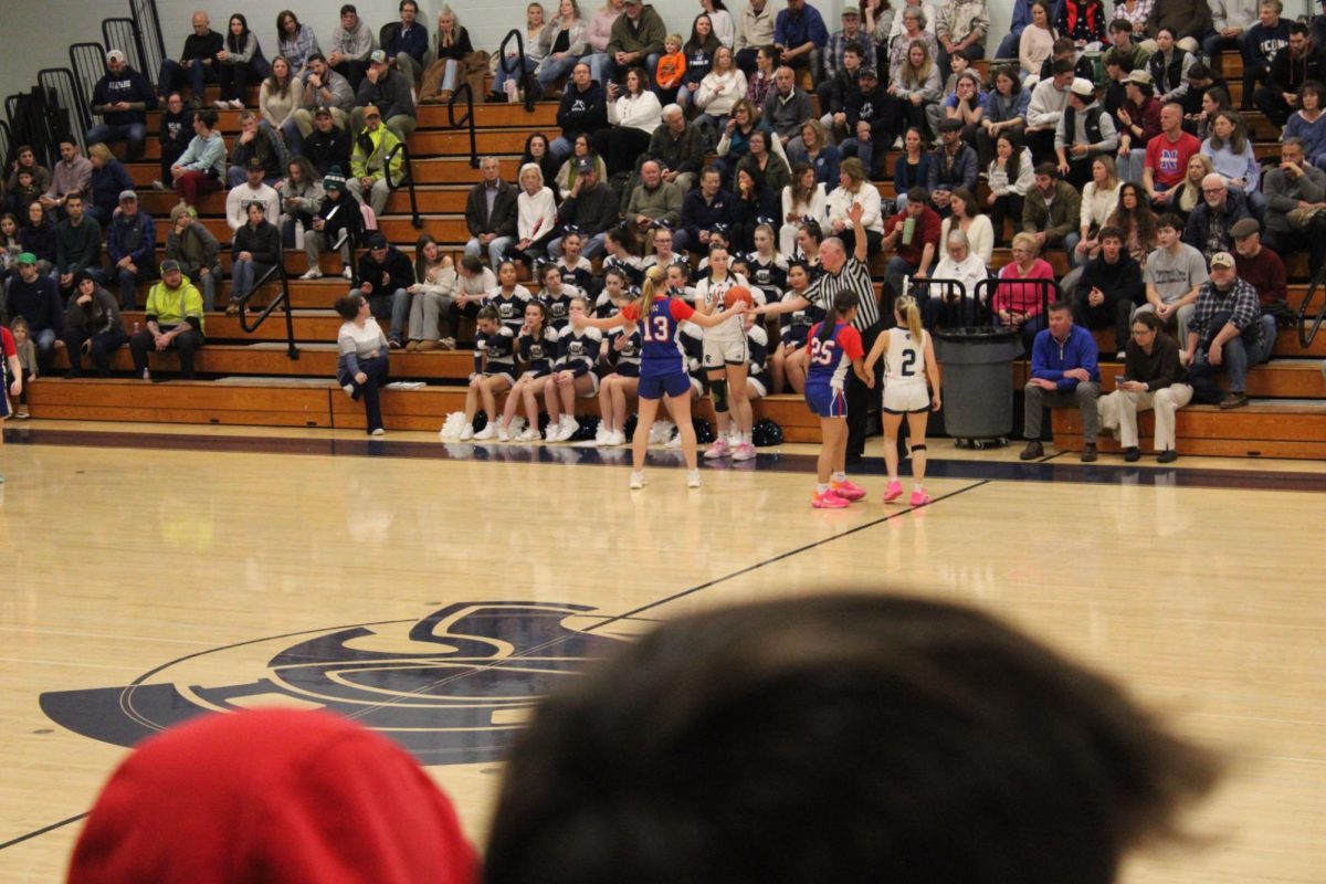 Eliza Butkus and Maiah Rodriguez play defense.