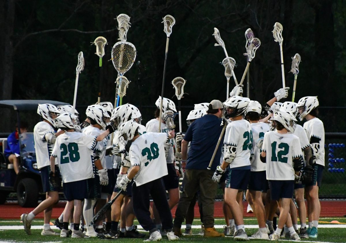 The Lakeview Boys Lacrosse team huddles up before a game. The team puts their sticks up high in hopes of winning their game on May 7, 2025 against Holy Cross. (Courtesy of Marianthe Glynos)