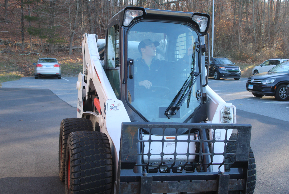 As the winter months close in, the ag classes work to make room in the garages to fit every piece of equipment to preserve it from the extreme weather that is growing nearer. Pictured here, Michael Venturini can be seen preparing to reorganize the available spaces with the skid steer. 