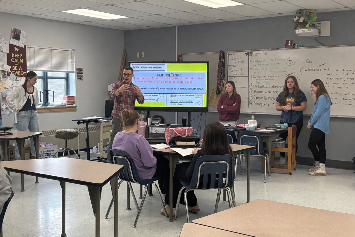 Many journalism students, along with one of three journalism teachers, Conor Gereg, stand at the front of the class teaching eighth graders about journalism. The investigative journalism unit happens every year in eighth grade. 