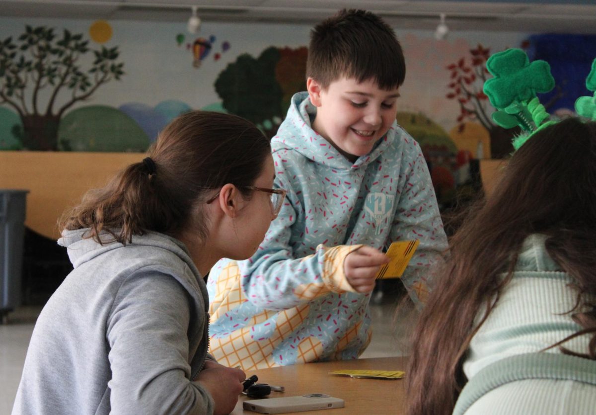 NHS senior Rachel Evon works with Liam, a MES fourth grader during a hands-on activity. The LEAD program bridges NHS students with community elementary school students for mentoring opportunities. 