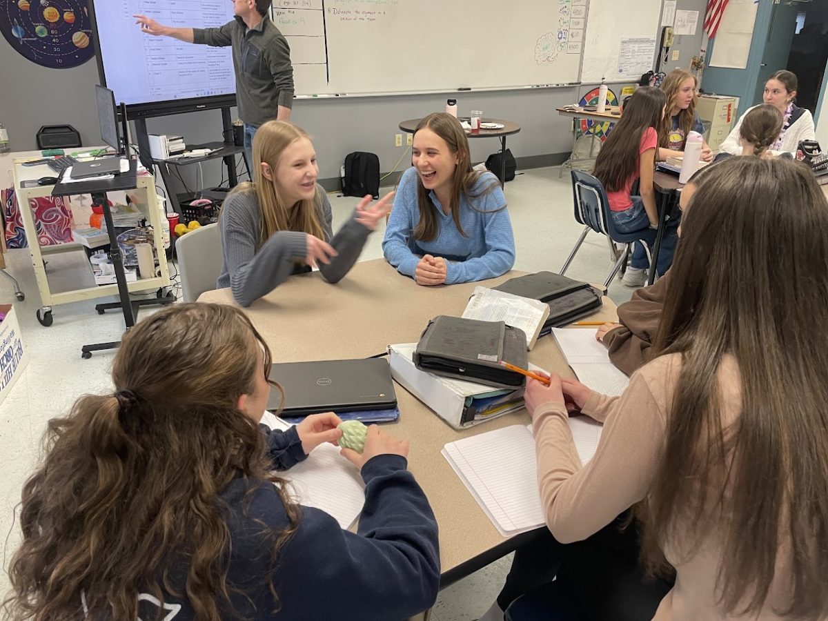Nonnewaug High School students Hope Davis (Left) sits by fellow freshman Sam Savulak from the journalism elective at Nonnewaug High School visit Woodbury Middle School to inform the 8th grade class taught by Adam Brutting about the journalism elective and to teach them the skills they need to be successful in writing a journalism story. (Contributed)