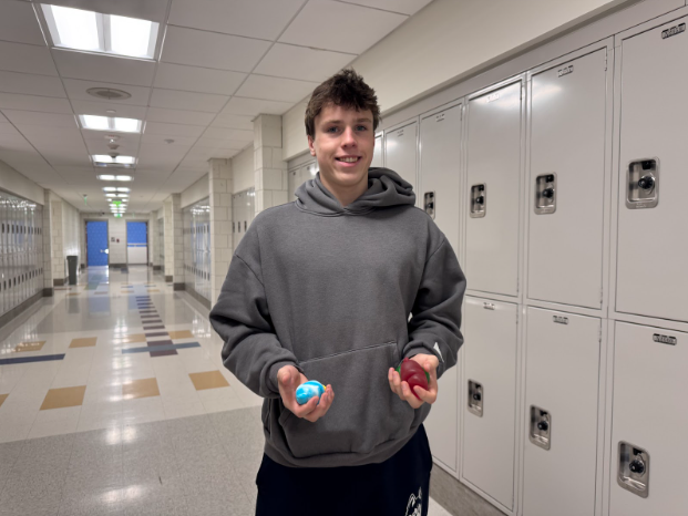 Nonnewaug senior Jake Cenatiempo holds Needohs and squishies while doing interviews for his journalism class. This trend has taken over Nonnewaug, but it is not the first time squishies have come around. 
