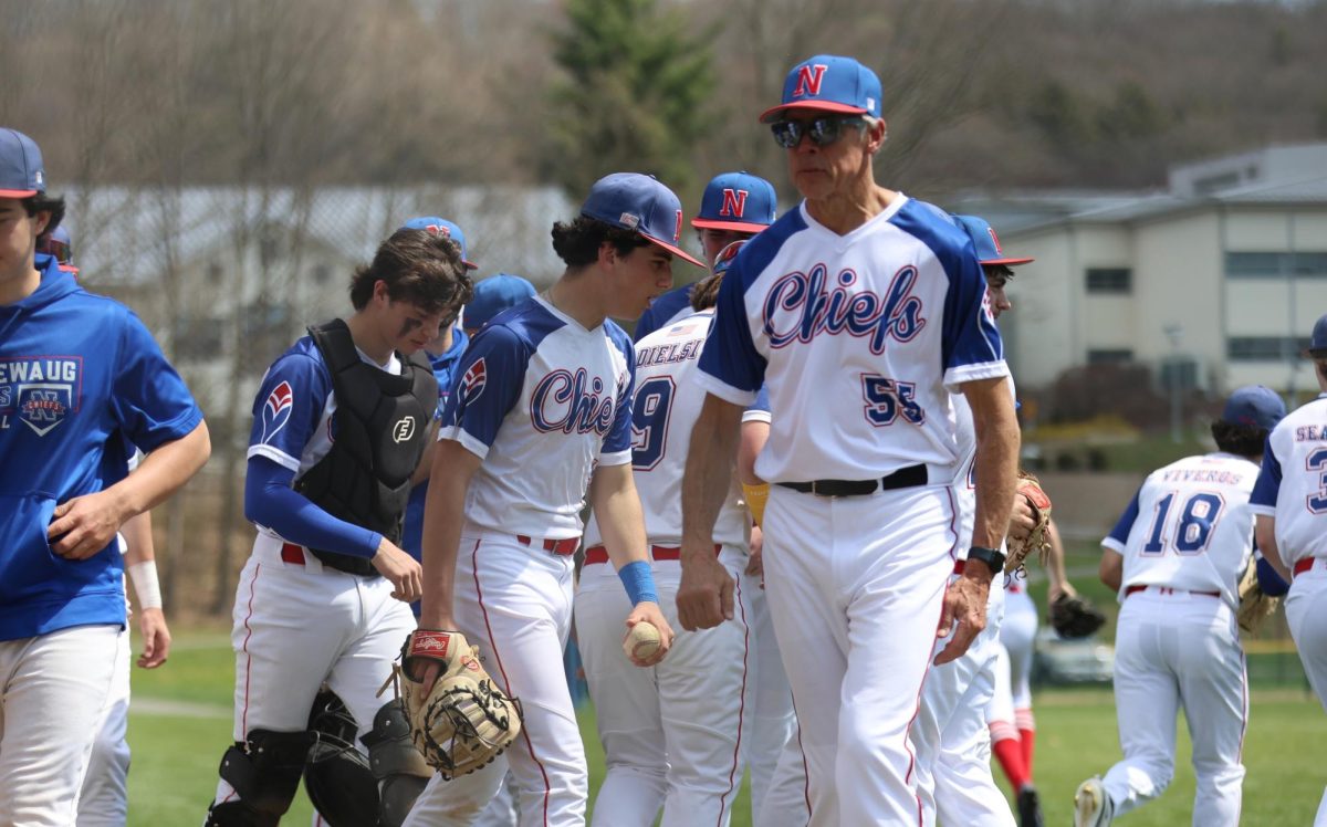 Coach Don Maki (right) exits the pre-game huddle on April 14th against Fairfield. Maki is already playing a key role in the baseball season so far. (Photo Credit - Noreen Chung)