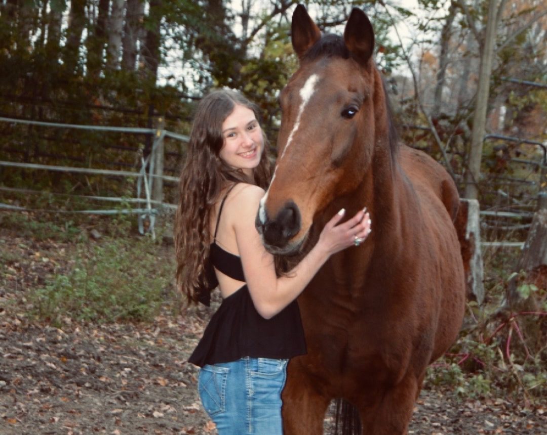 Gabby Distefano with her favorite horse Page. They are enjoying a nice warm fall afternoon, you can always find Distefano with a horse. (Courtesy of Gabby Distefano)