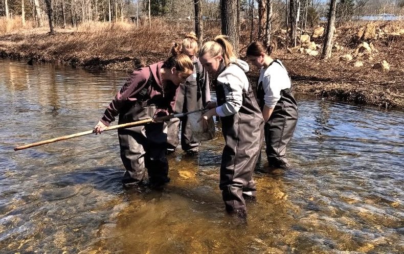 Aquaculture students stepped into a local stream, trading desks for waders as they did hands-on work analyzing water quality and aquatic life. This experience emphasized real-world application of classroom lessons, this gives students a deeper understanding of ecosystems y watching it in real life. (Courtesy of Woodbury FFA) 