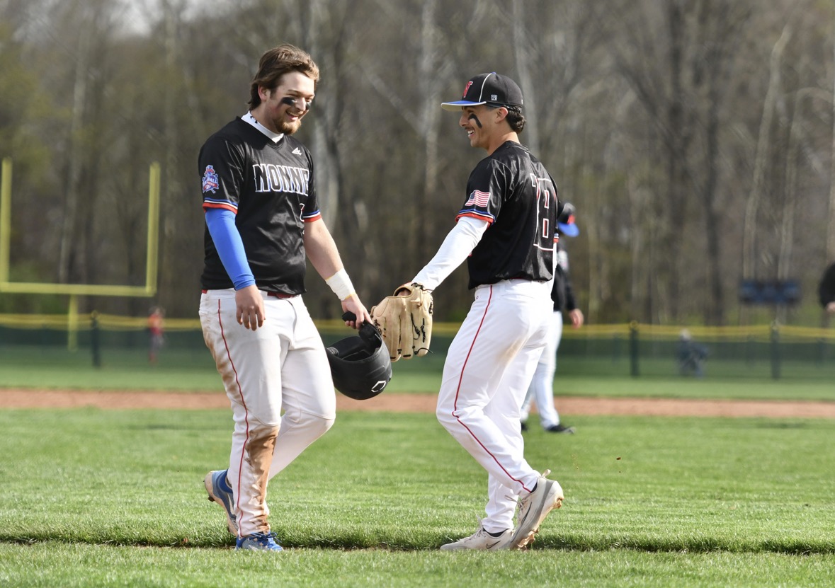 From left Tyler Dielsi greets Scott Viveros as the inning switches over on April 20 at the NHS baseball game against Northwestern. The chiefs won 4-3. 