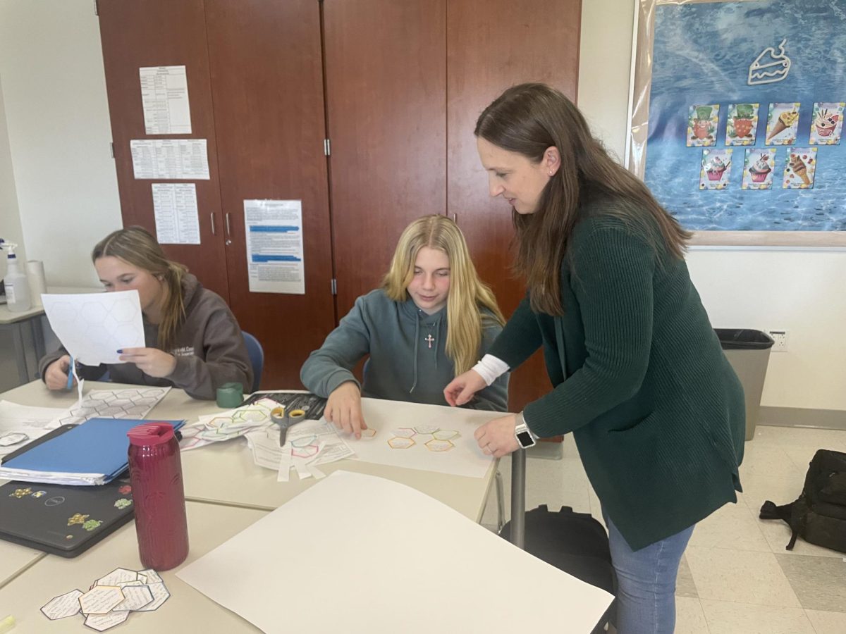 Jessica McKay helps students work on a project during her Advancement Placement Seminar class. McKay goes out of her way to make sure her students understand their assignments and materials for her class.
