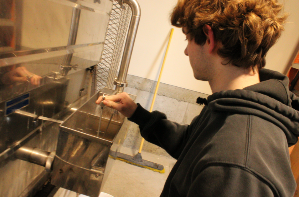 Nate Berry, a senior in the Natural Resources class, working on the evaporator in the sugar shack. This piece of machinery is a crucial part of the maple syrup and Nonnewaug is one of the few schools in our area lucky enough to have one on campus. 