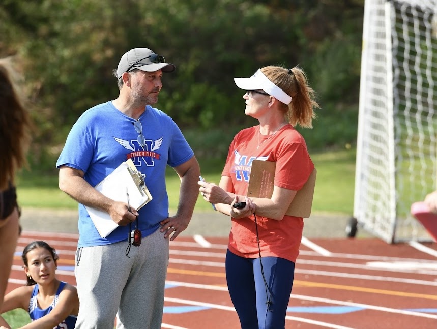 Deb Flaherty strategizes with her husband and coach Joe Flaherty during the track and field home meet vs. Lakeview and Shepaug high schools on May 4, 2026. The Flaherty’s head coach the track and field team together, creating a supportive, collaborative environment for athletes to thrive. 